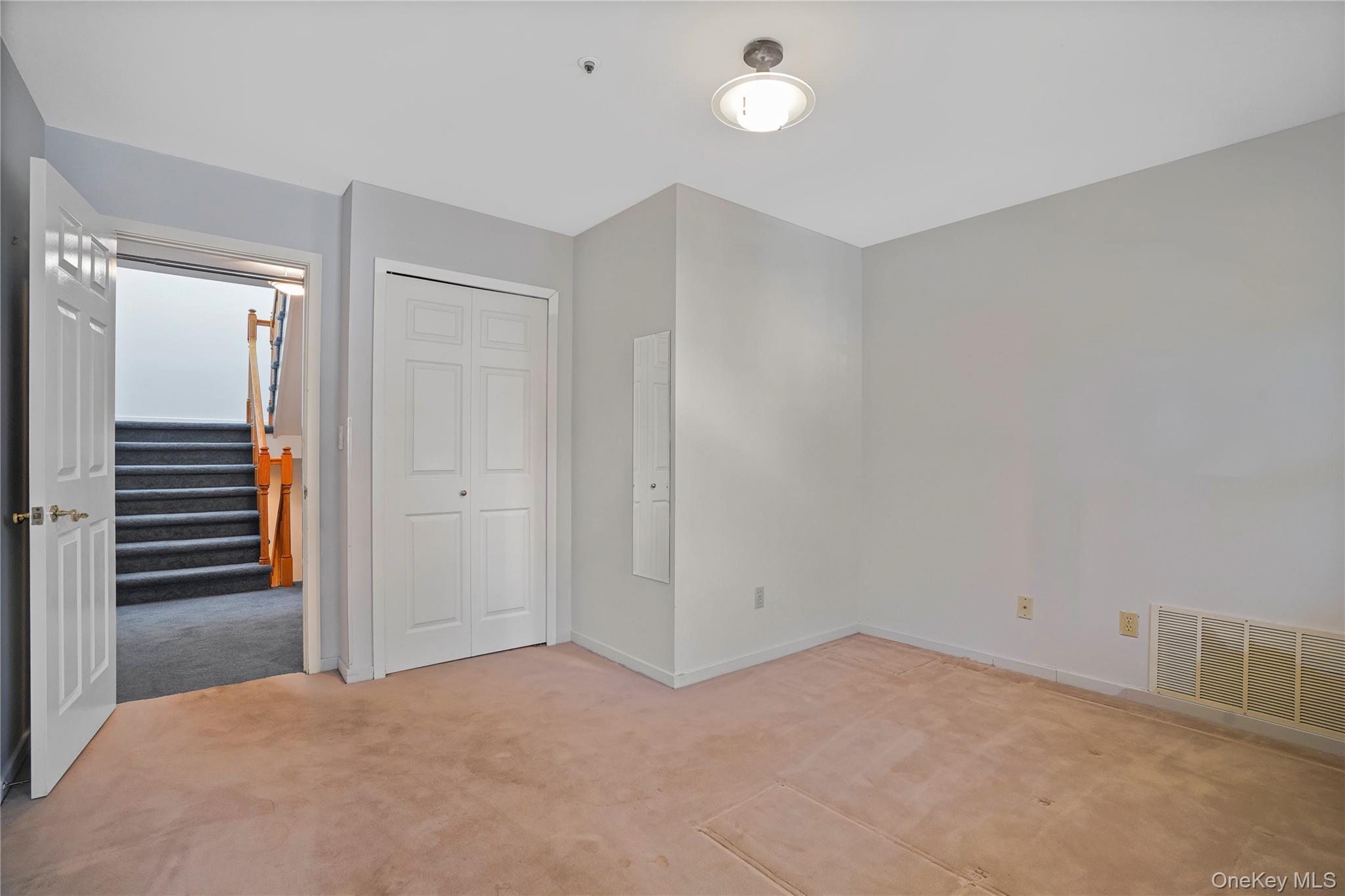 208 Boulder Ridge Road Scarsdale, NY 10583 - Photo 20 of 43 Unfurnished bedroom with light colored carpet and a closet