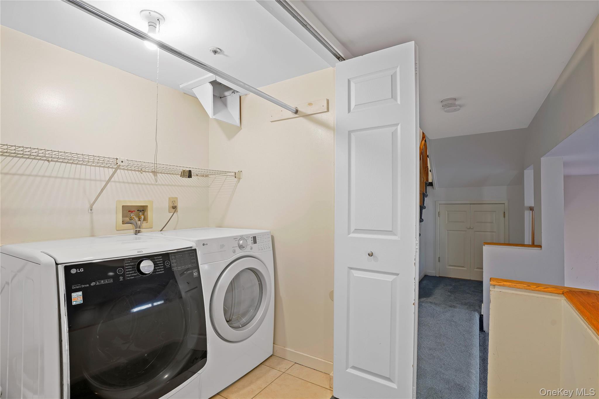 208 Boulder Ridge Road Scarsdale, NY 10583 - Photo 25 of 43 Laundry area with washer and dryer and light tile patterned floors