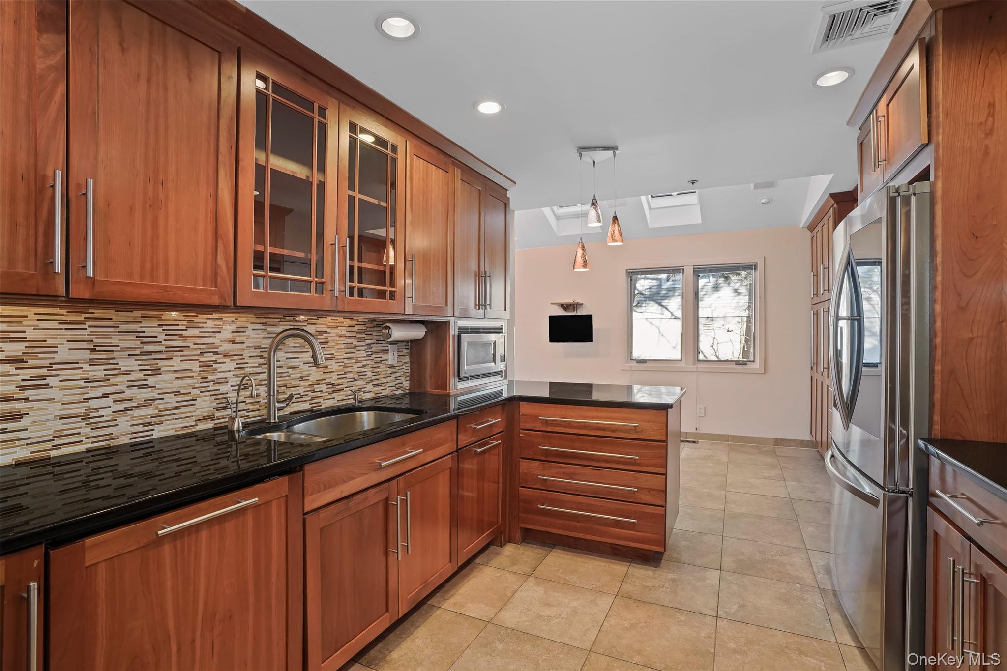 208 Boulder Ridge Road Scarsdale, NY 10583 - Photo 4 of 43 Kitchen featuring glass insert cabinets, brown cabinets, and recessed lighting