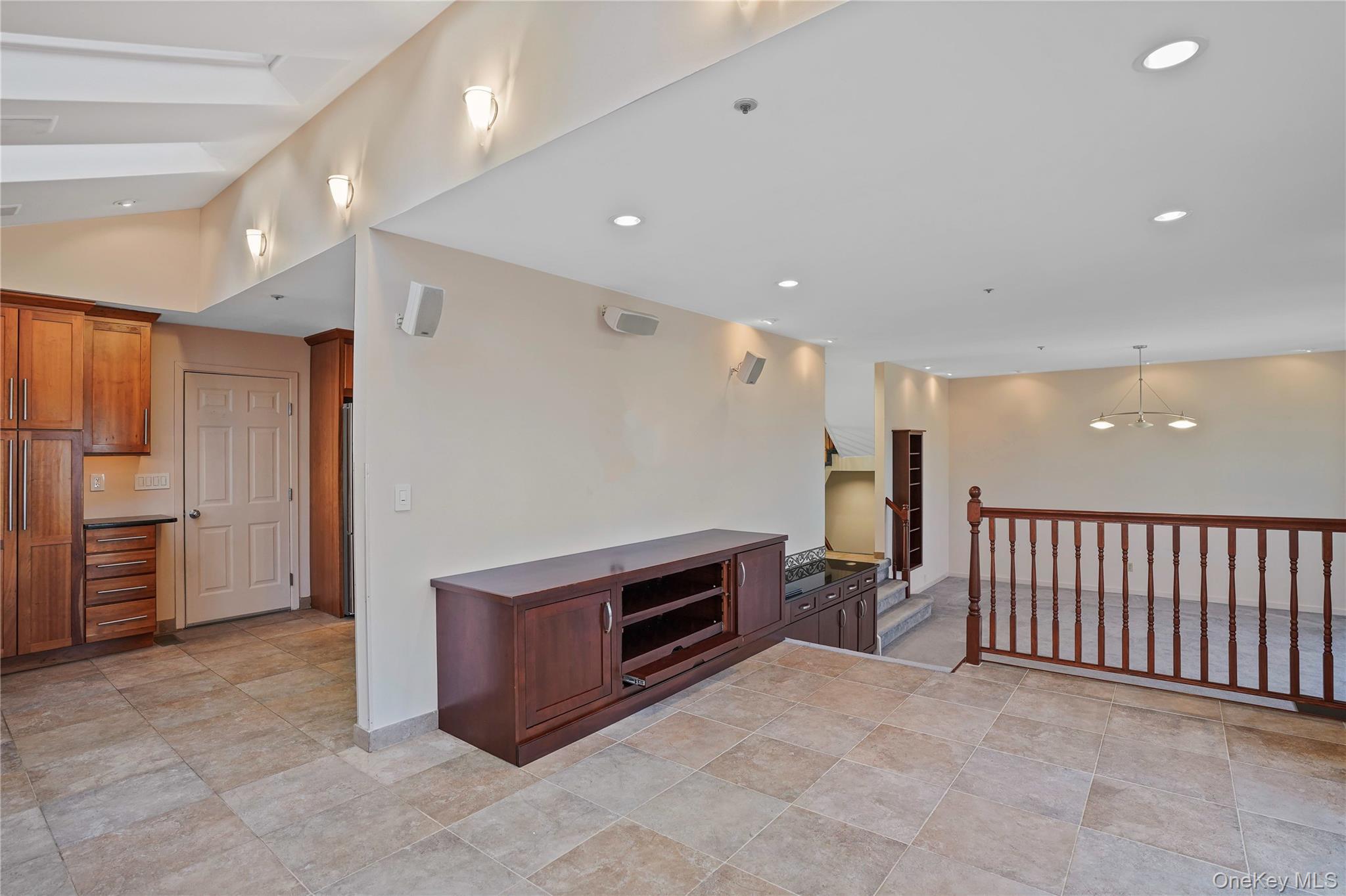 208 Boulder Ridge Road Scarsdale, NY 10583 - Photo 9 of 43 Kitchen with dark countertops, recessed lighting, hanging light fixtures, brown cabinetry, and a chandelier