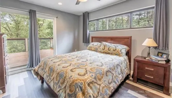 a bedroom with a bed and wooden floor