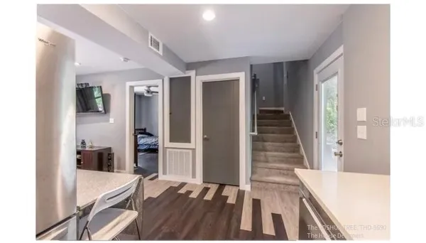 a bathroom with a sink vanity mirror and toilet