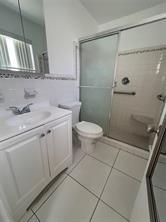 3614 Taylor Street Hollywood, FL 33021 - Photo 12 of 20 a bathroom with a sink a toilet and shower