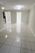 a view of a livingroom with an empty space and a window