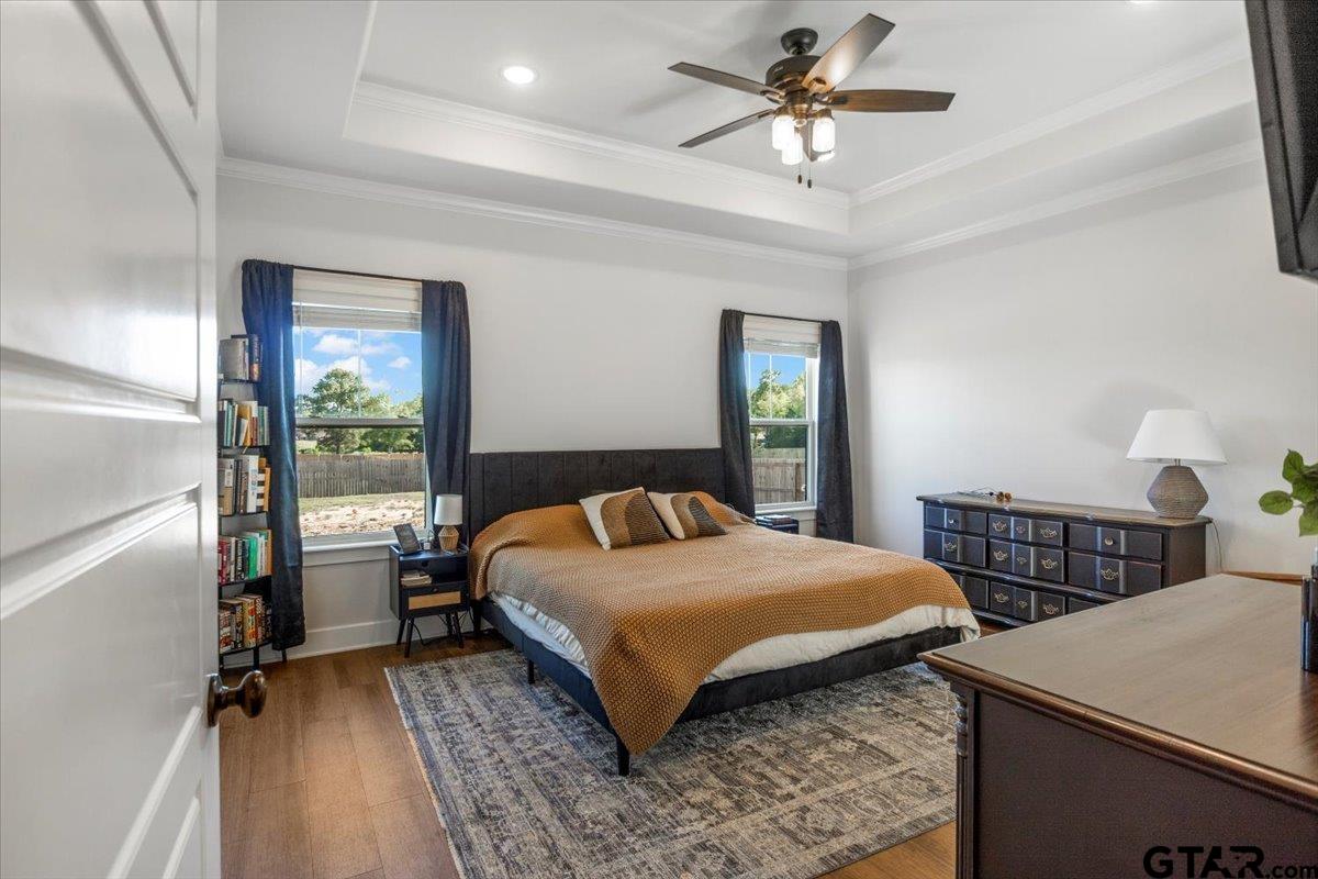 681 Peavine Road Kilgore, TX 75662 - Photo 16 of 27 a bedroom with a bed and a table with lamp