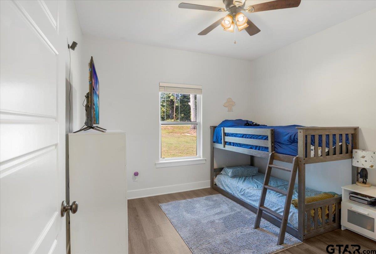 681 Peavine Road Kilgore, TX 75662 - Photo 21 of 27 a bedroom with furniture and a window