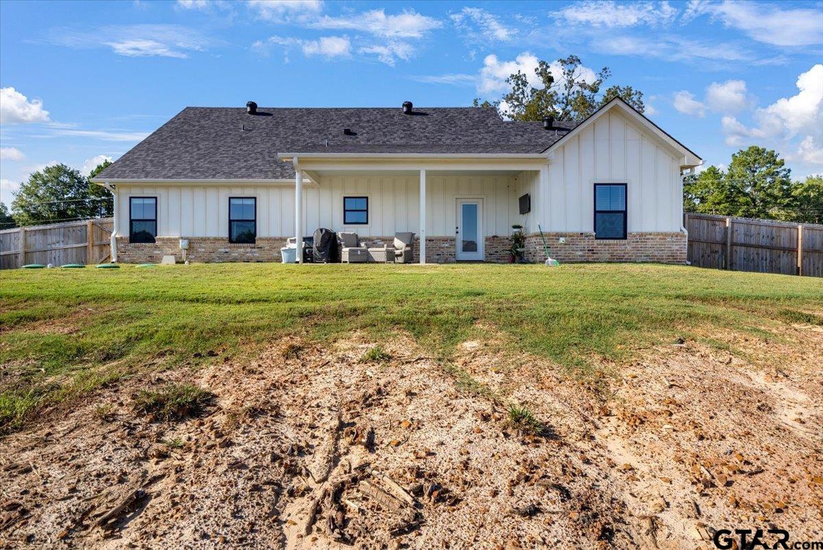 681 Peavine Road Kilgore, TX 75662 - Photo 26 of 27 a front view of a house with a garden and porch