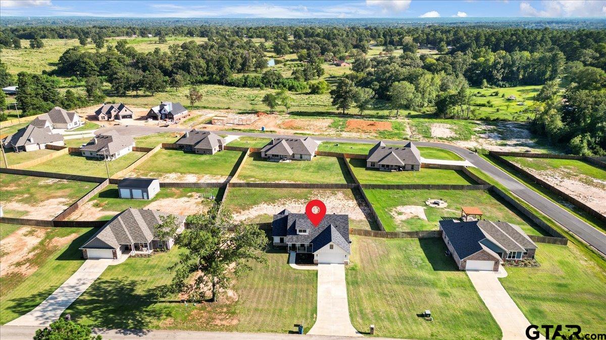 681 Peavine Road Kilgore, TX 75662 - Photo 5 of 27 a view of swimming pool with seating area and trees in the background