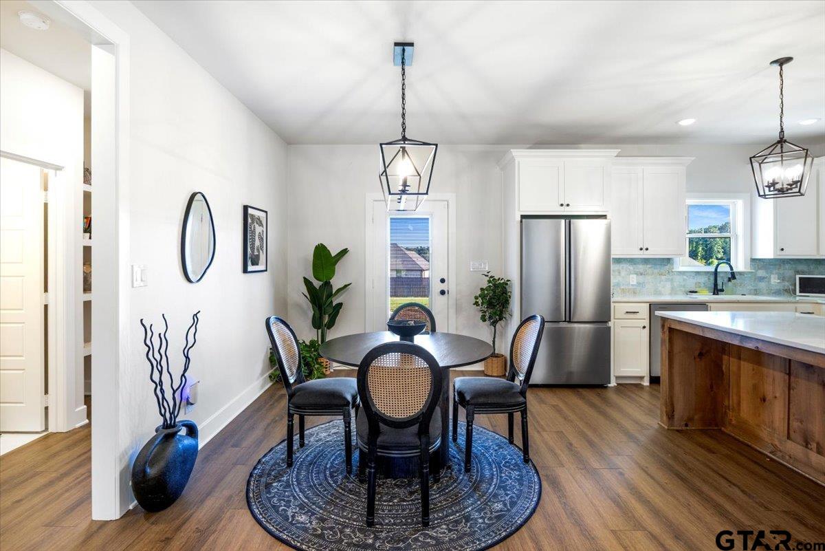 681 Peavine Road Kilgore, TX 75662 - Photo 9 of 27 a view of a dining room with furniture window and wooden floor