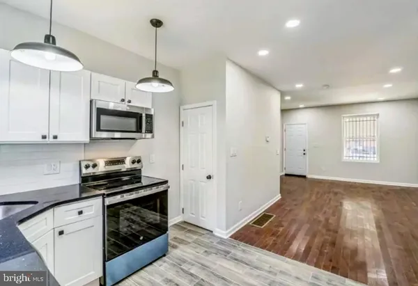 a kitchen with wooden floor cabinets and a wooden floor