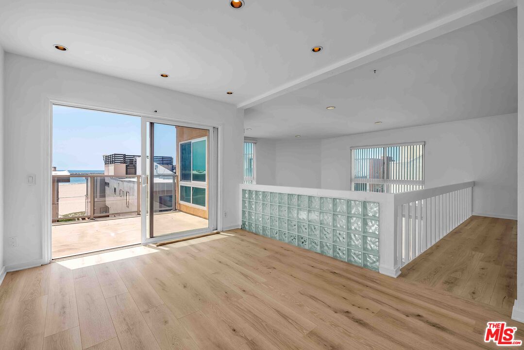15 63rd Avenue, Unit 3 Playa del Rey, CA 90293 - Photo 15 of 34 a view of an empty room with wooden floor and bedroom