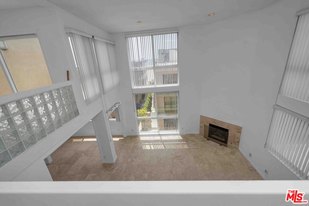 15 63rd Avenue, Unit 3 Playa del Rey, CA 90293 - Photo 16 of 34 a living room with a fireplace and a window
