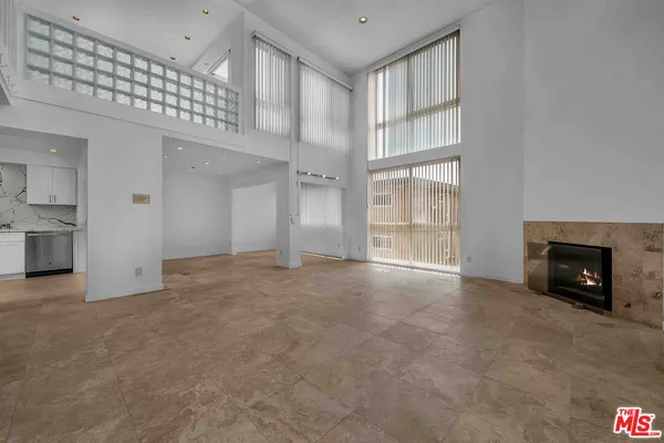 a view of an empty room with a fireplace