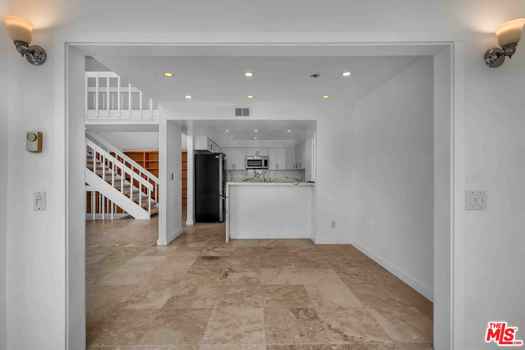 15 63rd Avenue, Unit 3 Playa del Rey, CA 90293 - Photo 7 of 34 a view of an empty room with kitchen and a window