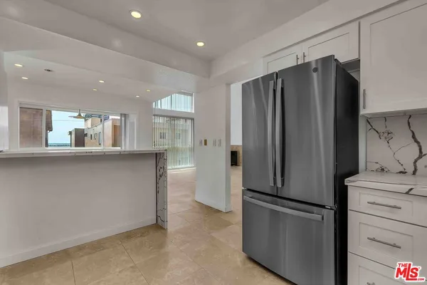 a kitchen with stainless steel appliances a refrigerator and a stove