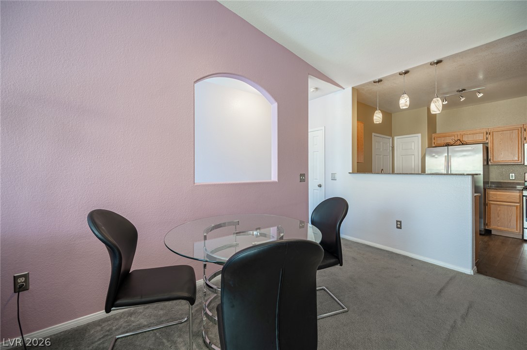 10550 West Alexander Road, Unit 2014 Las Vegas, NV 89129 - Photo 43 of 43 An open floor plan connects the carpeted dining space to the adjacent kitchen.