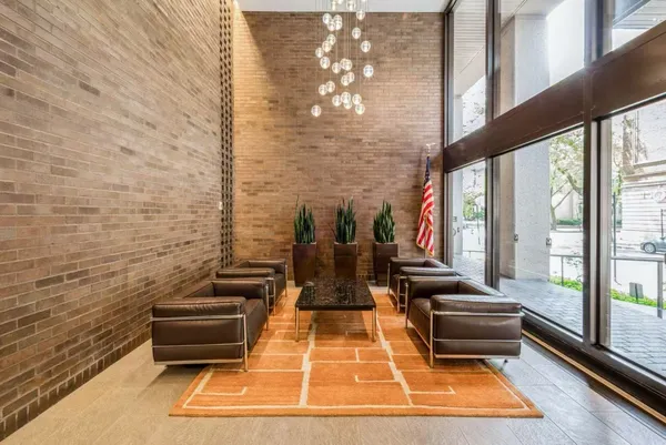 a view of a balcony with chairs and wooden floor
