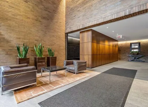 a lobby with furniture and a potted plant
