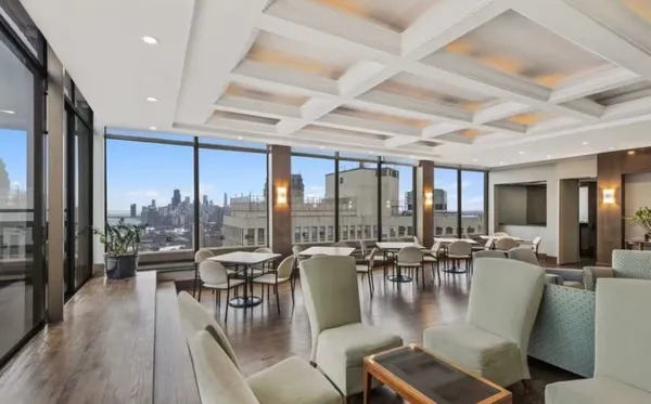 a dining room with furniture water view and large windows