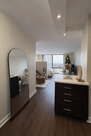 a view of living room with furniture and mirror