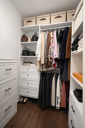 a view of walk in closet with clothes and shoes