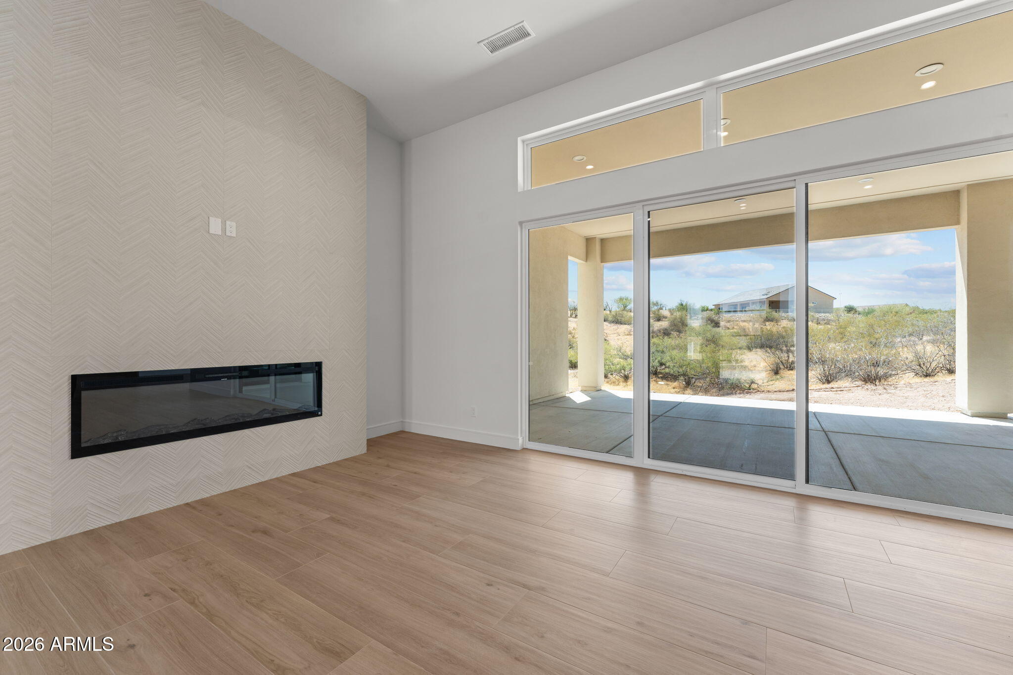 2855 Percheron Road Wickenburg, AZ 85390 - Photo 16 of 58 a view of an empty room with wooden floor and a window