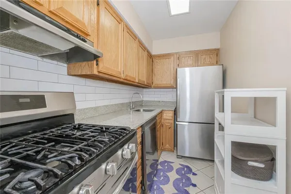 a kitchen with a stove a refrigerator and a stove top oven