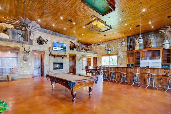 a living room with lots of furniture and pool table