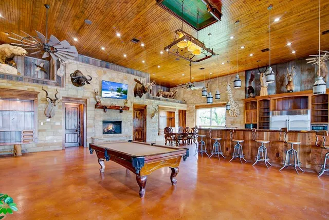 a living room with lots of furniture and pool table