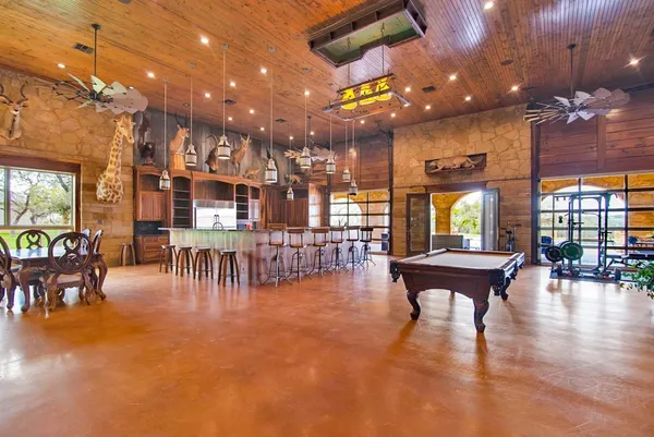 a dining room with furniture and a chandelier