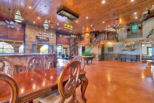 a view of a swimming pool with a patio and plants