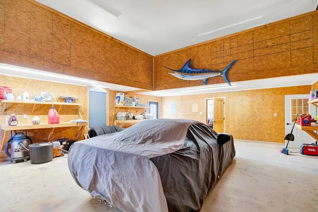 a bedroom with a bed and large windows