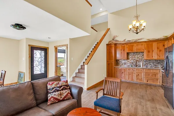 a living room with furniture and a chandelier