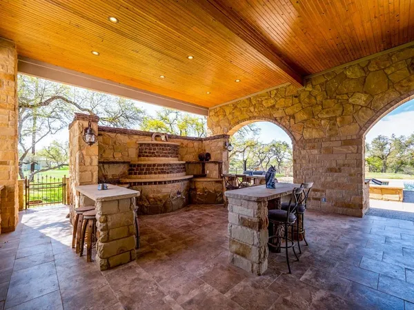 a view of a patio with a table and chairs