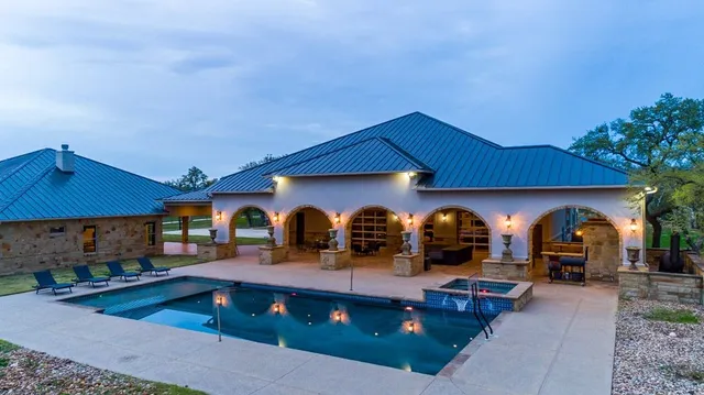 a view of house with outdoor space and swimming pool