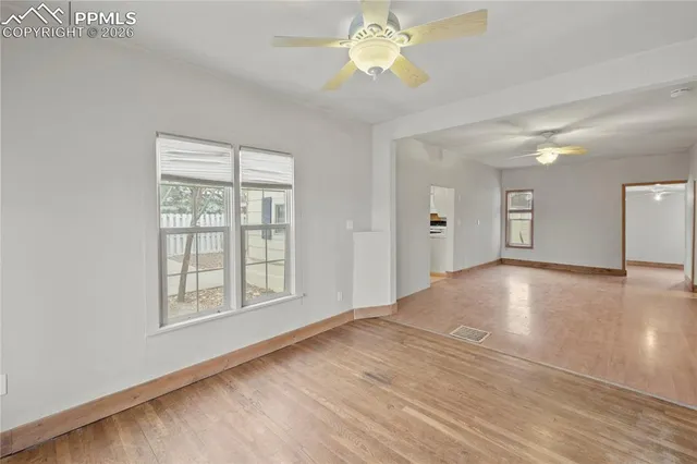 wooden floor in an empty room with a window