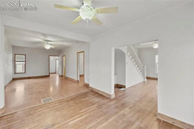 a view of a livingroom with a ceiling fan and hardwood floor