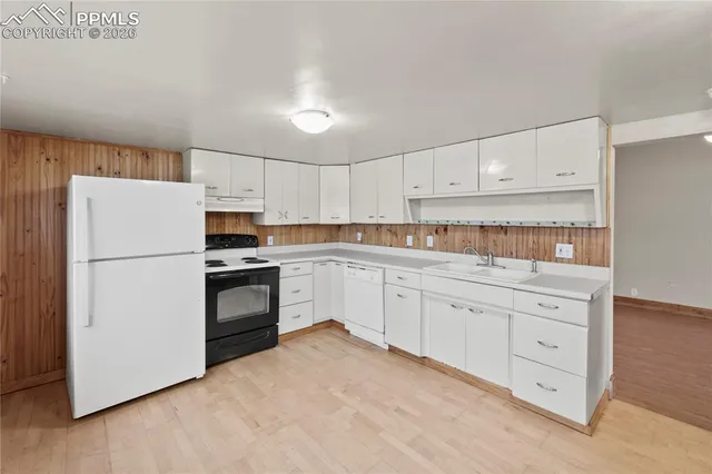 a kitchen with cabinets stainless steel appliances and sink