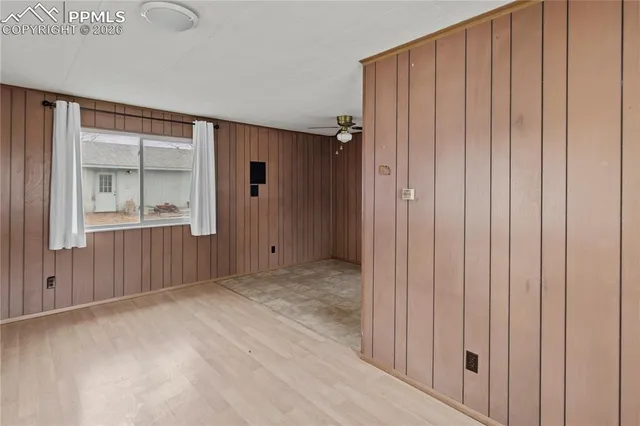 a view of an empty room with wooden door