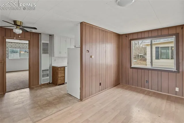 an empty room with closet and windows