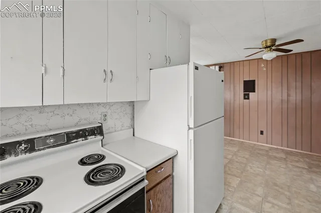 a white refrigerator freezer sitting inside of a kitchen