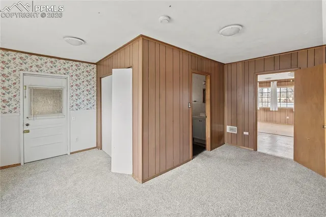 a big room with closet and windows