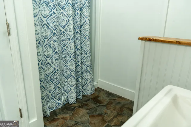 a bed sitting in a bedroom next to a cabinet