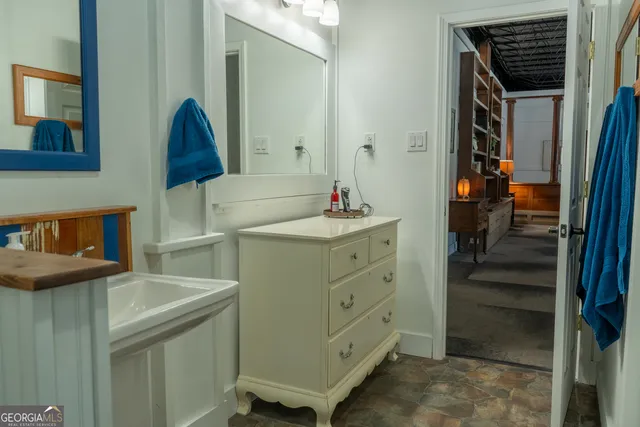 a view of an entryway with a flower pot and wooden floor