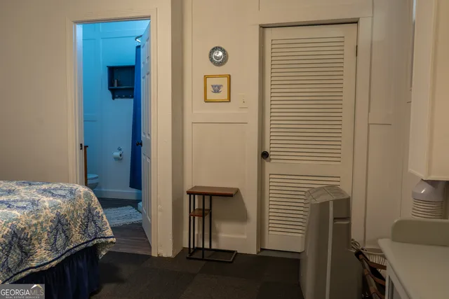 a kitchen with a table chairs a refrigerator and a stove