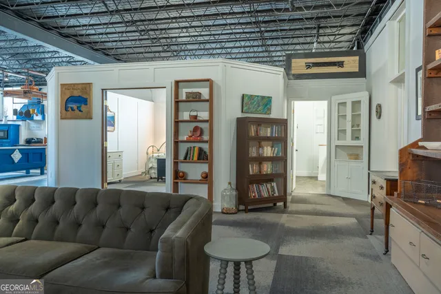 a kitchen with stainless steel appliances wooden floor and chandelier
