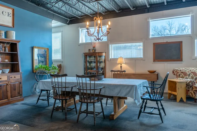a living room with furniture a chandelier and a piano