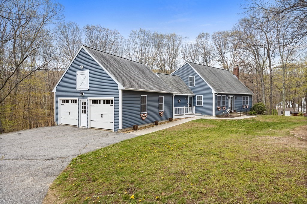 71 Old Worcester Road Charlton, MA 01507 - Photo 1 of 24 a front view of a house with a garden and trees