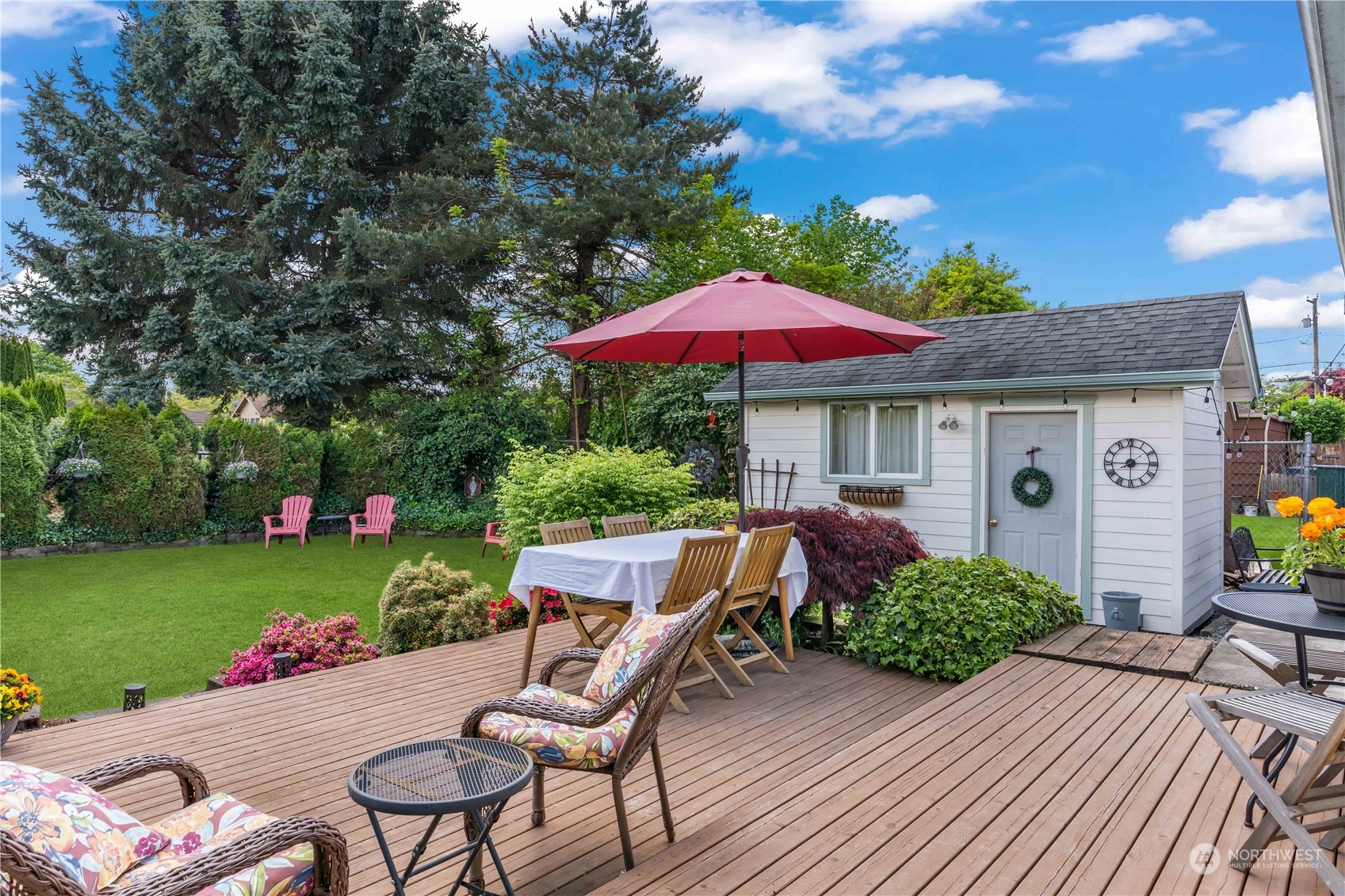 1616 Maple Street Sumner, WA 98390 - Photo 24 of 40 a view of a house with backyard sitting area and garden