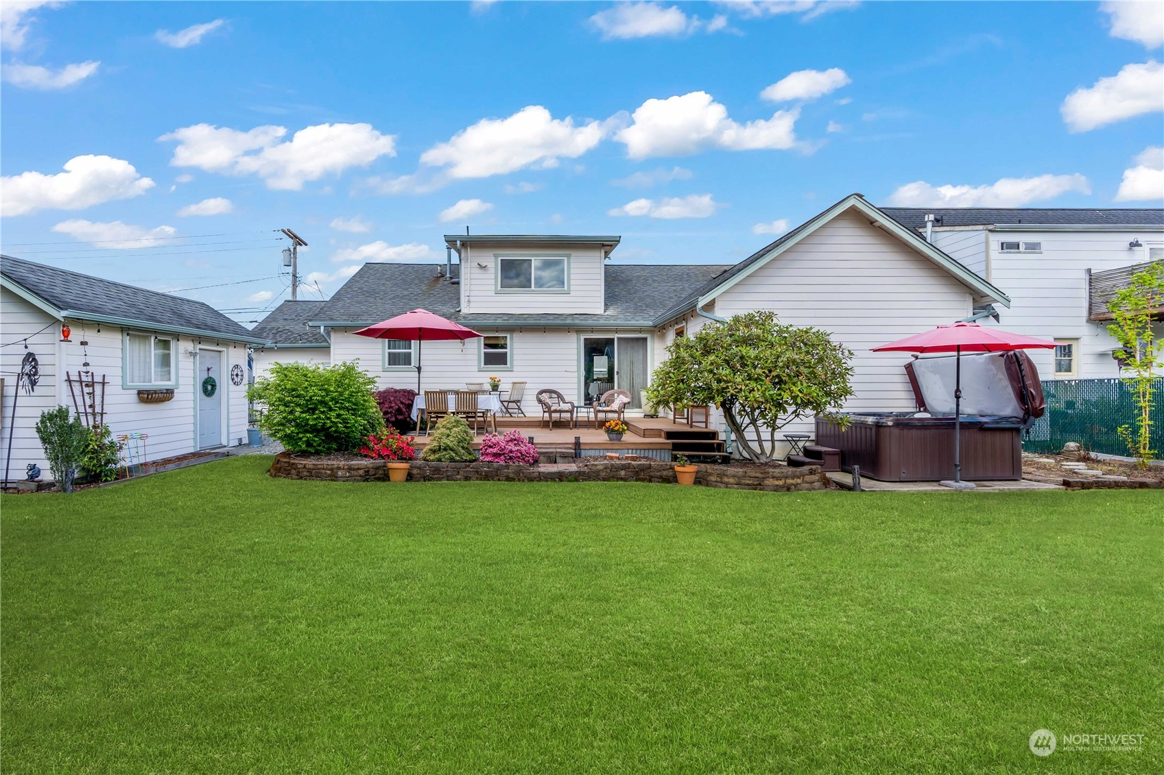 1616 Maple Street Sumner, WA 98390 - Photo 30 of 40 a view of a house with a garden and a patio